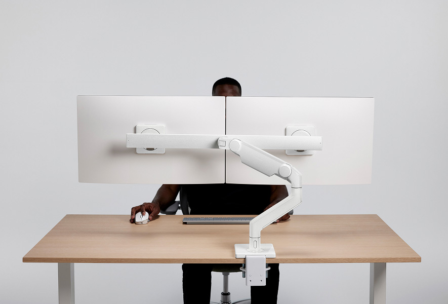 Individual using M/Flex M8 Pro, dual monitor sitting at desk